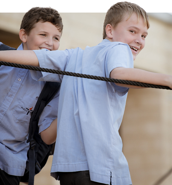 Two middle school-aged boys playing on the playground.