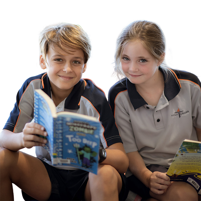 A male and female student holding open books and smiling at the camera.