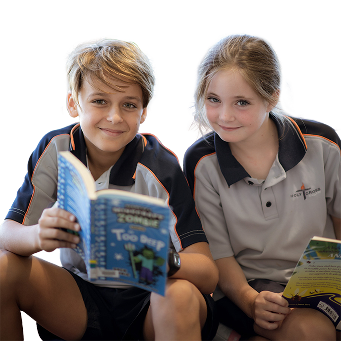 A male and female student holding open books and smiling at the camera.