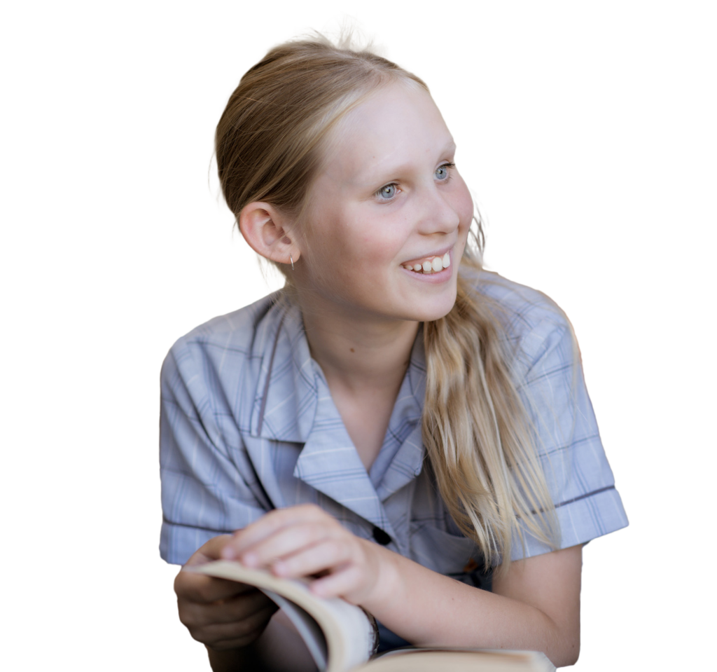 Middle-school aged, blonde female student smiling to the side while holding an open book.