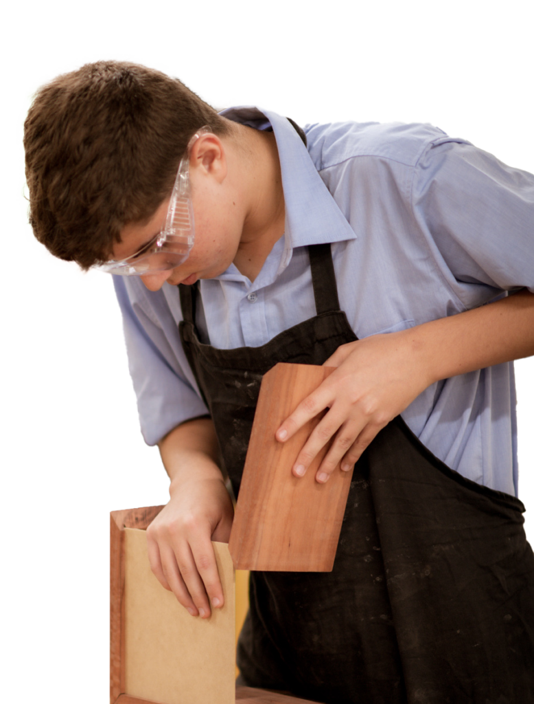Male student putting together a wooden box in Woodwork class.
