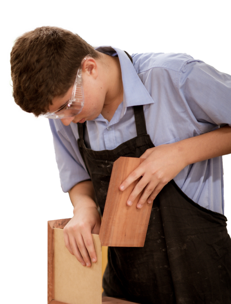 Male student putting together a wooden box in Woodwork class.