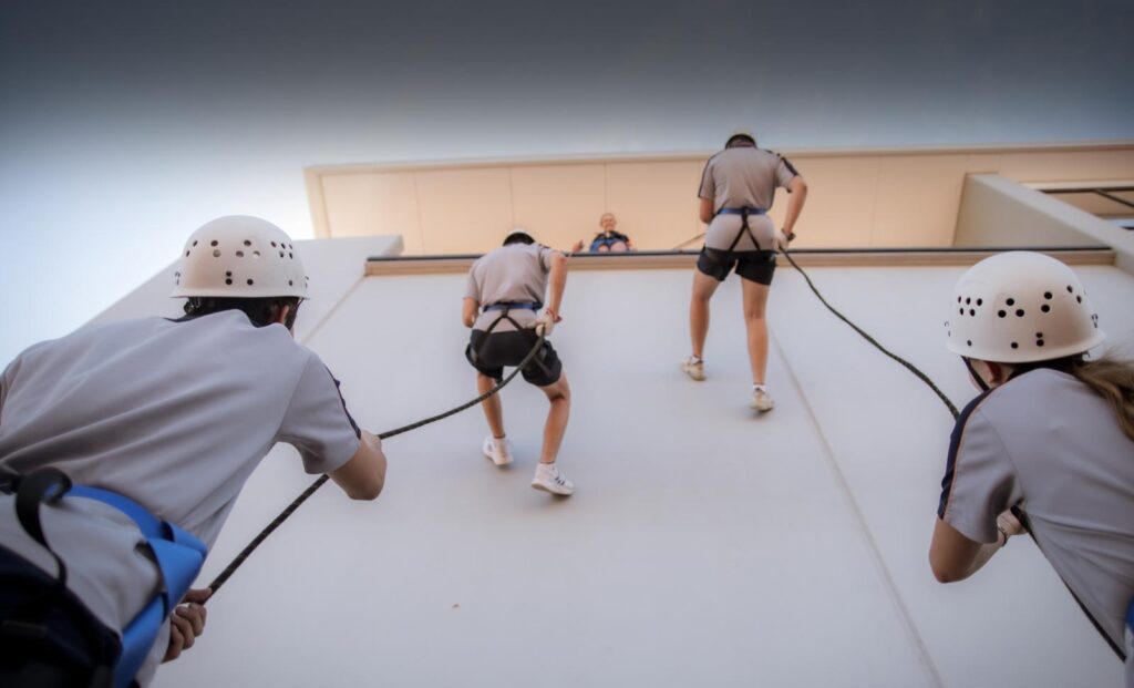 Students abseiling down a wall at Holy Cross College